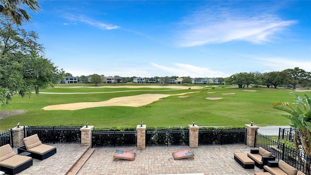 view of property's community with a yard and a patio area