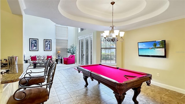 recreation room featuring an inviting chandelier, a tray ceiling, french doors, and pool table