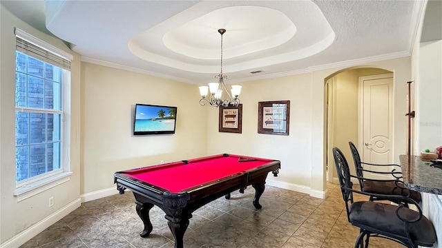 game room with billiards, an inviting chandelier, a tray ceiling, and crown molding