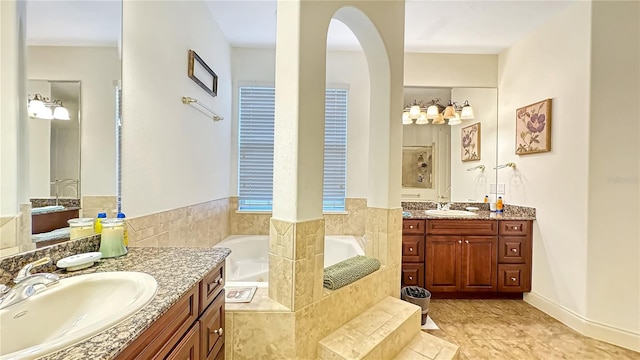 bathroom with dual vanity, tile floors, and tiled tub