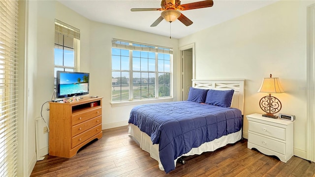 bedroom with ceiling fan and dark wood-type flooring