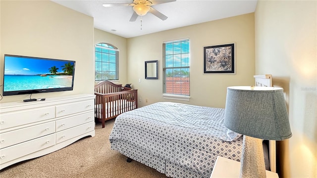 bedroom with ceiling fan and light carpet