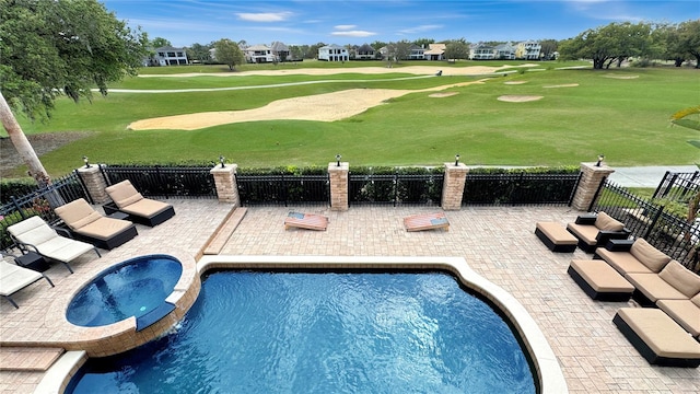 view of pool with a yard, a patio area, and an in ground hot tub