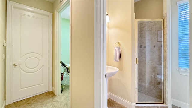 bathroom with toilet, tile flooring, and an enclosed shower