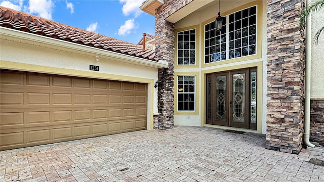 property entrance featuring french doors and a garage