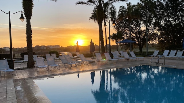 pool at dusk with a patio