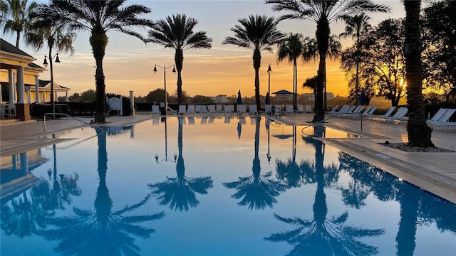 view of pool at dusk