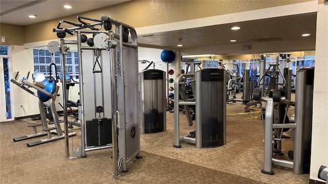 workout area with dark colored carpet