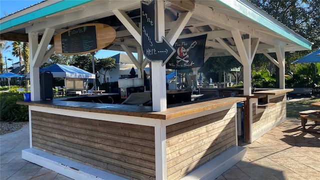 view of patio / terrace featuring a gazebo and an outdoor bar