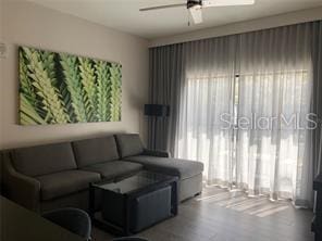 living room featuring ceiling fan and wood-type flooring