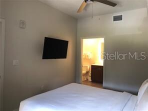 bedroom featuring ensuite bathroom and ceiling fan