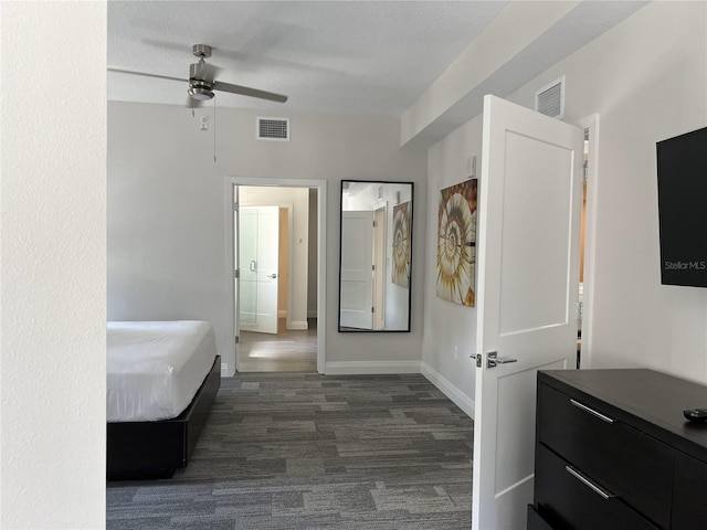 bedroom featuring ceiling fan, ensuite bath, and a textured ceiling