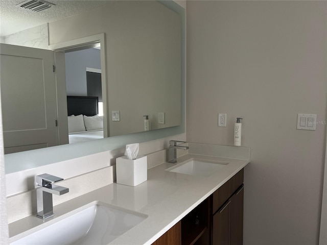 bathroom with vanity and a textured ceiling