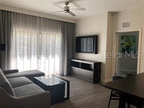 living room featuring hardwood / wood-style flooring and ceiling fan