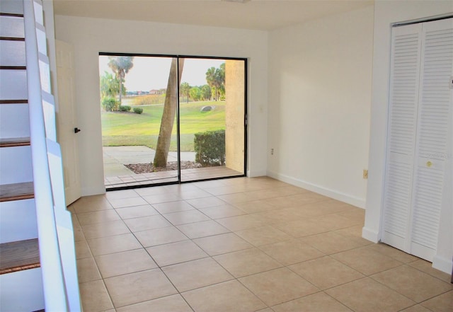 empty room with light tile floors and a wealth of natural light