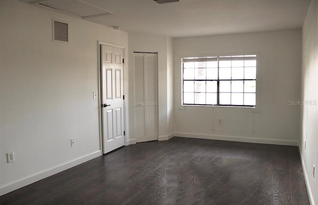 empty room with dark hardwood / wood-style floors