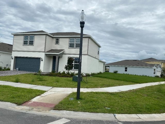 view of front of house with a front yard and a garage