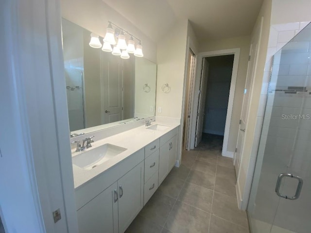 bathroom featuring vanity, a shower with shower door, and tile patterned flooring