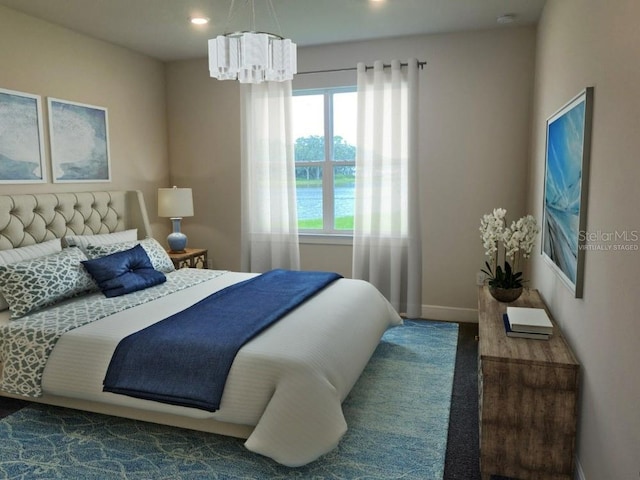 carpeted bedroom featuring a chandelier