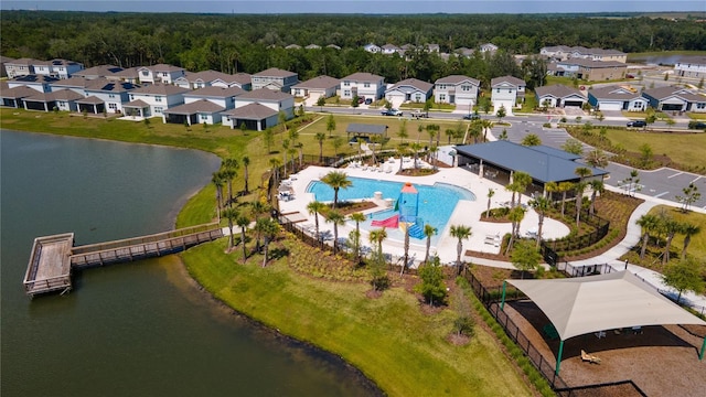 drone / aerial view featuring a residential view and a water view