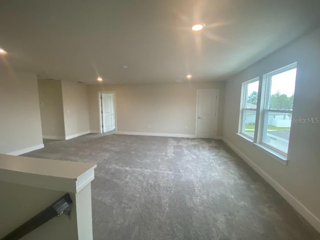 spare room featuring recessed lighting and baseboards