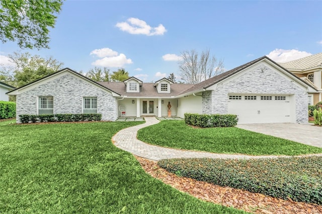 view of front of home featuring a front lawn and a garage