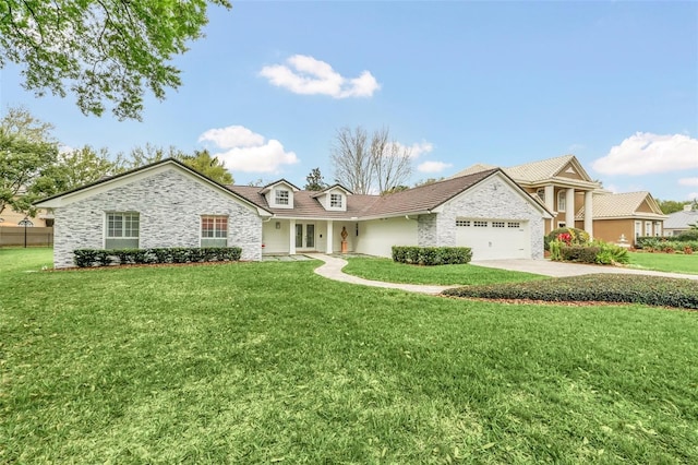 view of front of home with a front yard and a garage