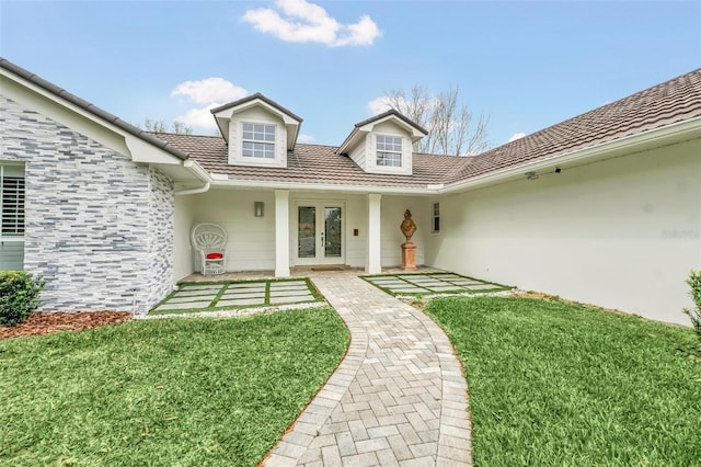 view of front of home featuring french doors and a front lawn