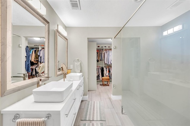 bathroom featuring vanity with extensive cabinet space, tile flooring, and double sink