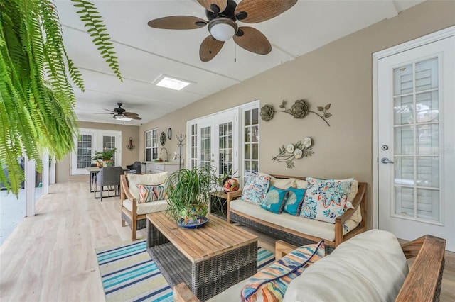 sunroom / solarium with french doors and ceiling fan