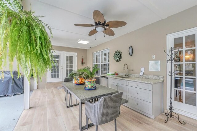 interior space with ceiling fan, sink, and light hardwood / wood-style flooring