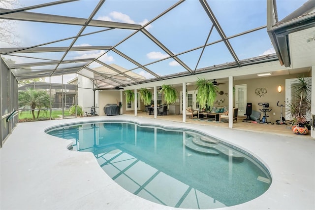 view of swimming pool with glass enclosure and a patio