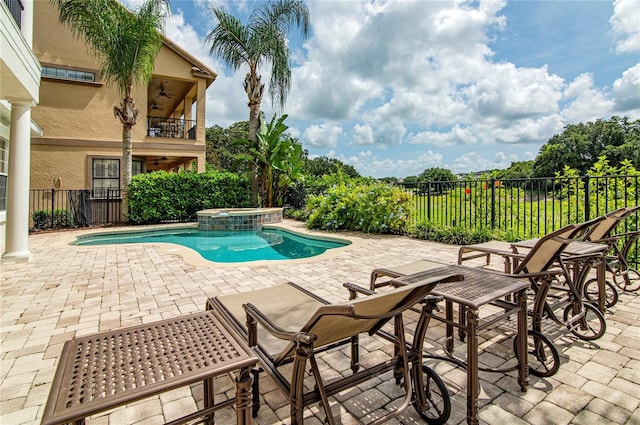 view of pool with an in ground hot tub and a patio area