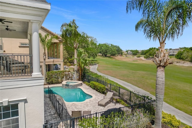 view of pool with an in ground hot tub, a yard, ceiling fan, and a patio