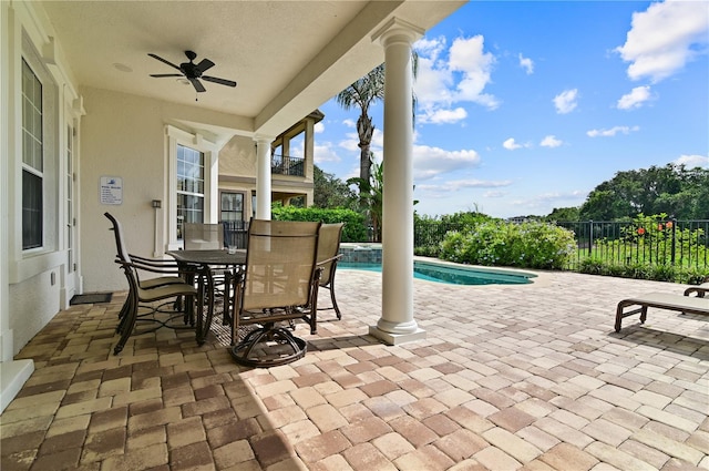 view of patio with ceiling fan and a fenced in pool