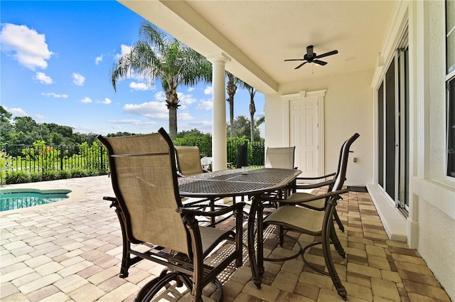 view of patio / terrace featuring ceiling fan and a fenced in pool