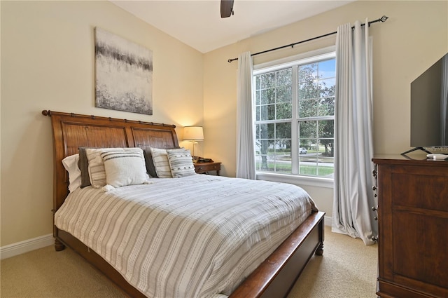 bedroom featuring light carpet and ceiling fan