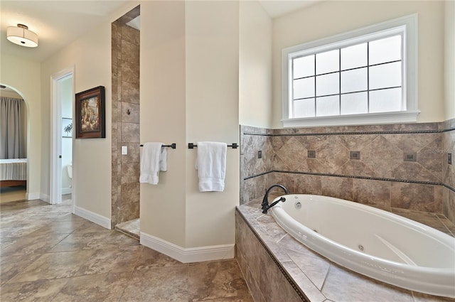 bathroom featuring a relaxing tiled tub