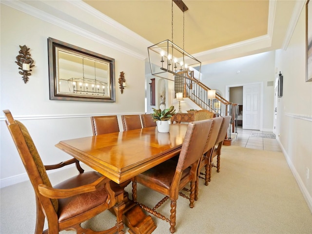 dining space featuring light colored carpet and ornamental molding