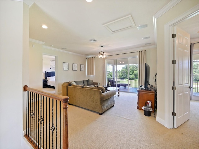 carpeted living room featuring ceiling fan and crown molding