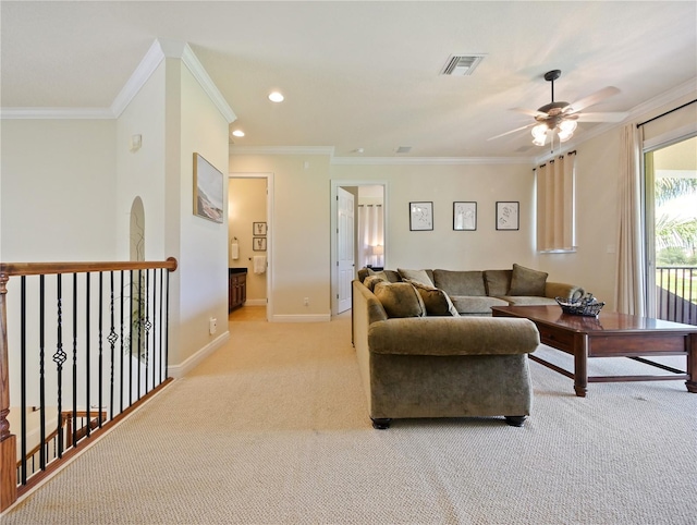 carpeted living room featuring ceiling fan and ornamental molding