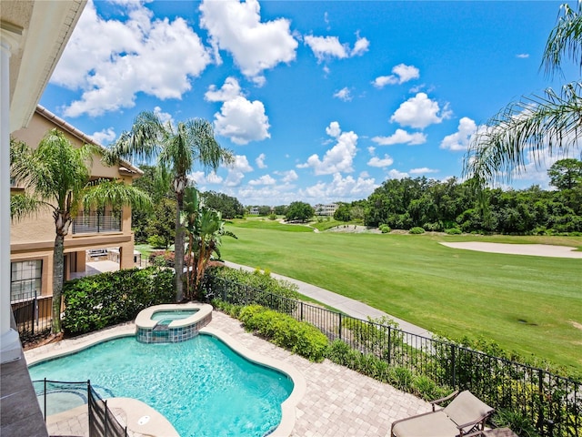 view of swimming pool featuring a patio area, a yard, and an in ground hot tub