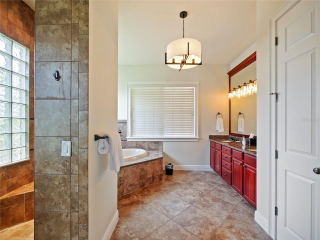 bathroom with vanity, an inviting chandelier, and shower with separate bathtub