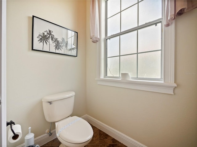 bathroom with toilet and tile patterned floors