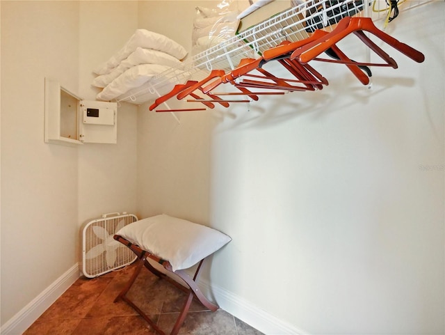 walk in closet with tile patterned floors