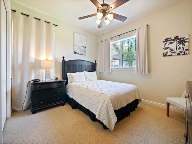 bedroom featuring light carpet and ceiling fan