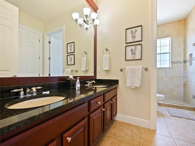 bathroom featuring a shower with shower door, vanity, a notable chandelier, and tile patterned floors