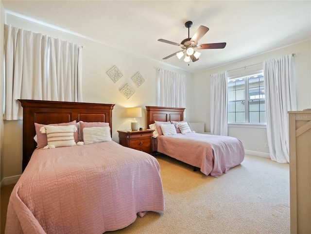 bedroom with ceiling fan and light colored carpet