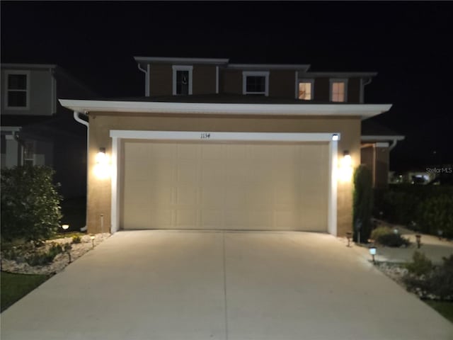 view of front of home with driveway and a garage