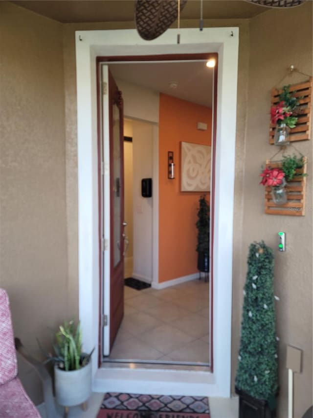 doorway to property featuring stucco siding